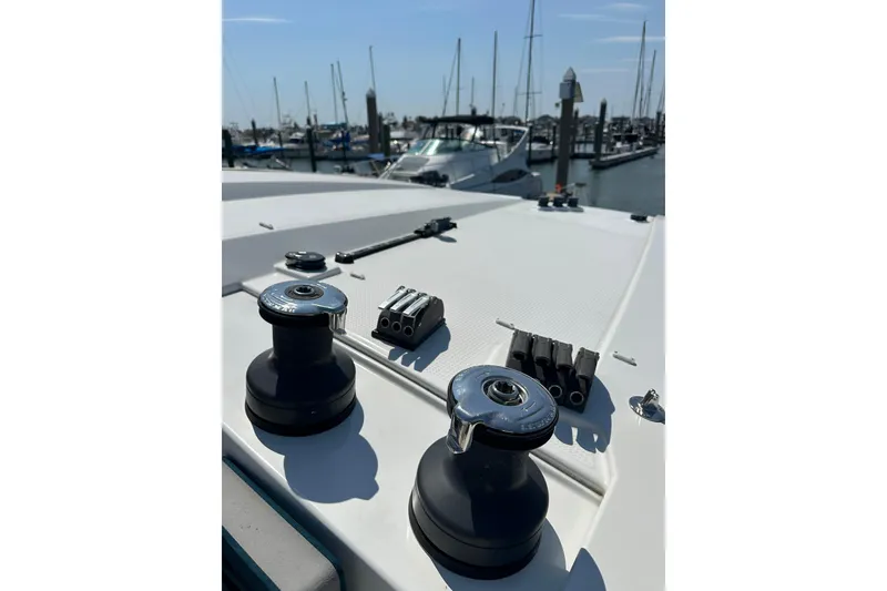 Slide: The Image of 2020 Fountaine Pajot Astrea 42 Catamaran deck with winches in a marina setting. - 83