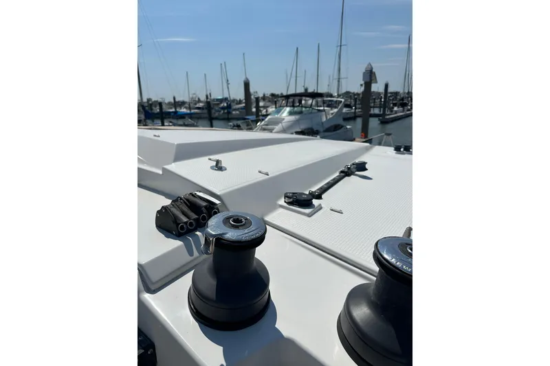 Slide: The Image of 2020 Fountaine Pajot Astrea 42 Catamaran deck with winches in a marina setting. - 84