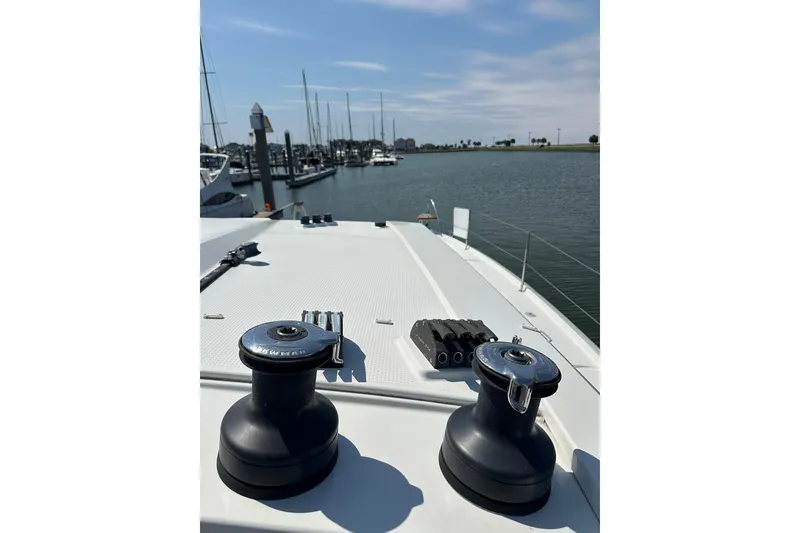 Slide: The Image of 2020 Fountaine Pajot Astrea 42 Catamaran deck with winches, docked at marina. - 87