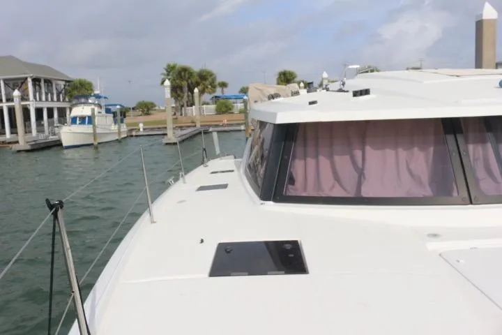 Slide: The Image of 2020 Fountaine Pajot Astrea 42 Catamaran docked at marina with palm trees. - 9