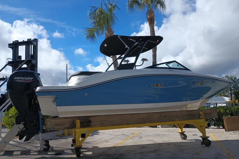 Slide: The Image of 2023 Sea Ray SPX 190 Outboard boat on trailer, under a clear blue sky. - 1