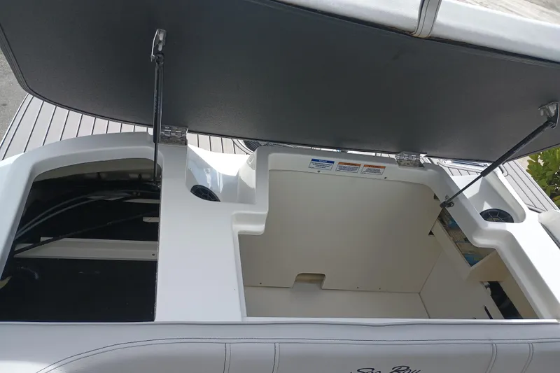 Slide: The Image of 2023 Sea Ray SPX 190 Outboard storage compartment with open hatch, showcasing interior space. - 21