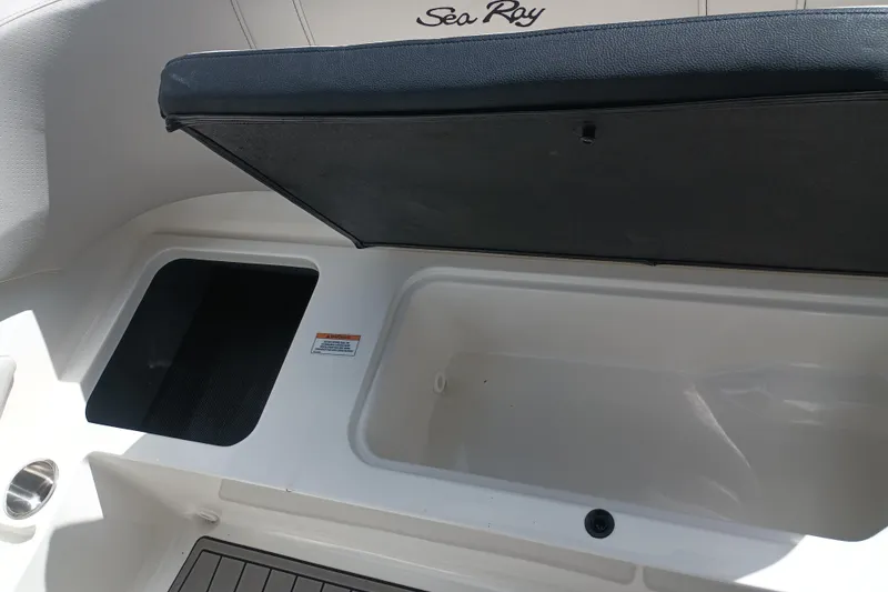 Slide: The Image of 2023 Sea Ray SPX 190 Outboard boat storage compartment with open lid. - 24