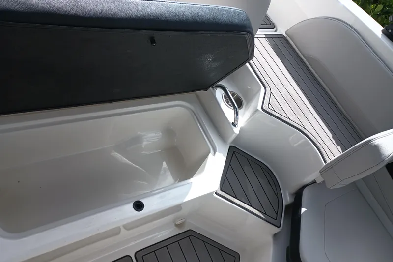 Slide: The Image of 2023 Sea Ray SPX 190 Outboard interior with storage compartment and seating. - 25