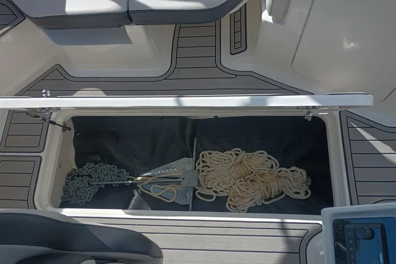 Slide: The Image of 2023 Sea Ray SPX 190 Outboard storage compartment with rope and anchor. - 26