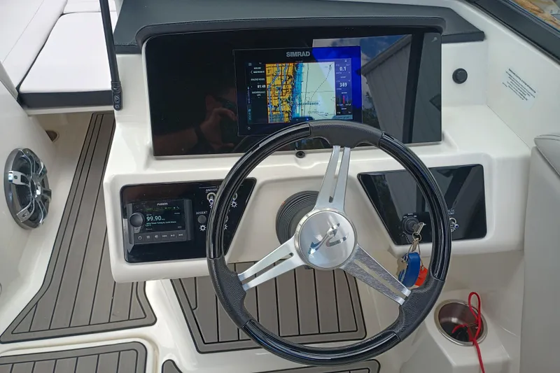 Slide: The Image of 2023 Sea Ray SPX 190 Outboard dashboard with steering wheel and navigation display. - 6