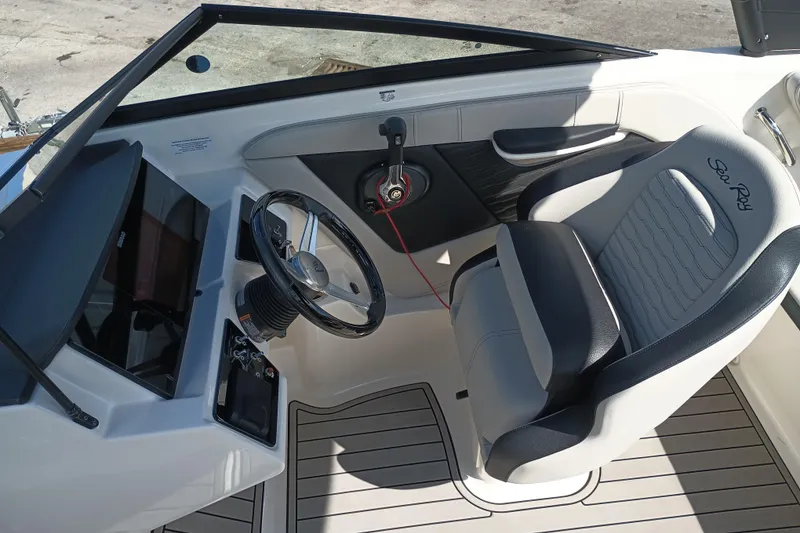 Slide: The Image of 2023 Sea Ray SPX 190 Outboard cockpit with steering wheel and comfortable seating. - 8