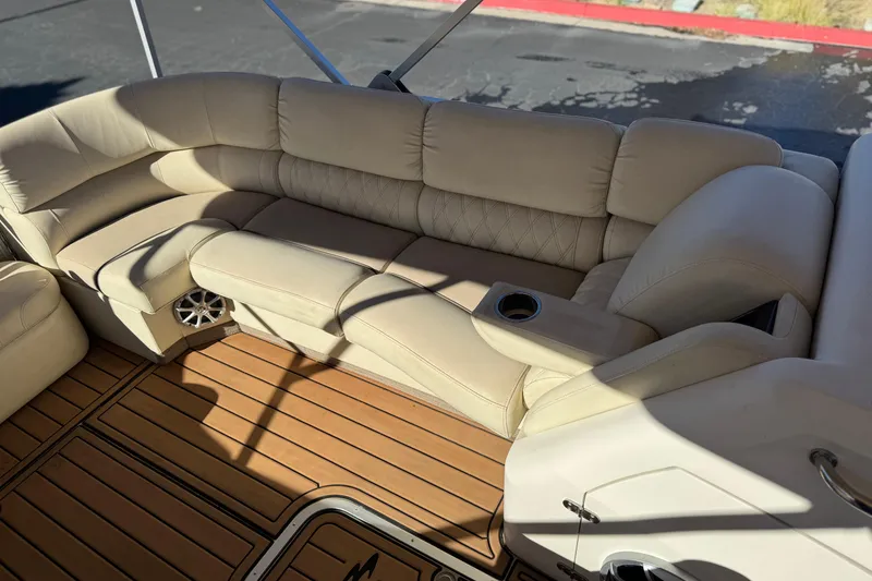 Slide: The Image of Luxurious seating on 2013 Bennington 2575QCW I/O boat with beige upholstery and wood flooring. - 16