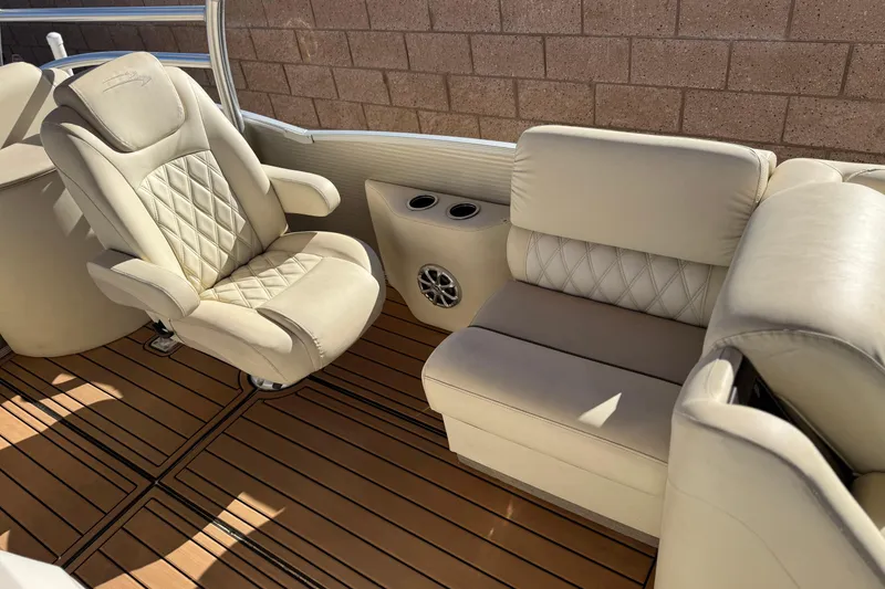 Slide: The Image of Luxurious interior of 2013 Bennington 2575QCW I/O boat with plush seating and wood flooring. - 20
