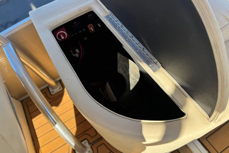 Slide: The Image of 2013 Bennington 2575QCW I/O boat interior with control panel and seating area. - 25