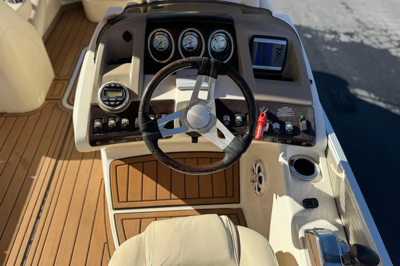 Slide: The Image of 2013 Bennington 2575QCW I/O boat dashboard with steering wheel and controls. - 32