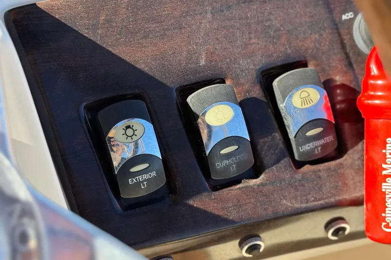 Slide: The Image of 2013 Bennington 2575QCW I/O boat dashboard with light switches for exterior, cupholder, and underwater. - 34