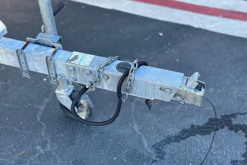 Slide: The Image of Trailer hitch of a 2013 Bennington 2575QCW I/O on asphalt surface. - 37