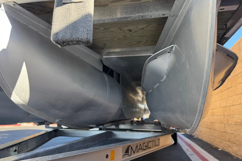 Slide: The Image of 2013 Bennington 2575QCW I/O pontoon boat underside on Magic Tilt trailer. - 4