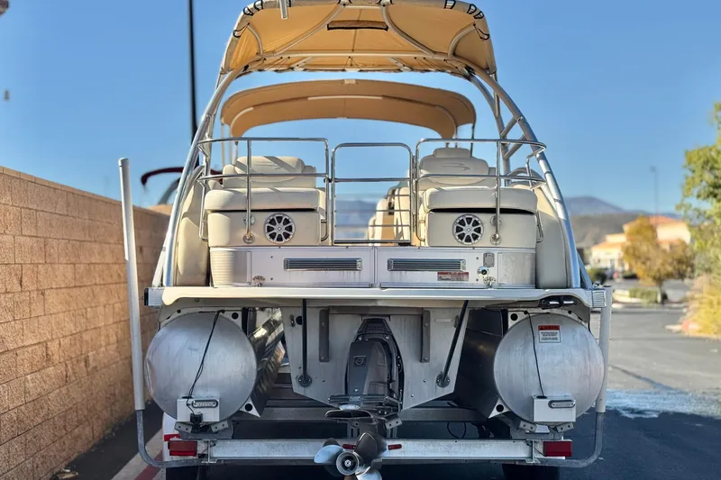Slide: The Image of 2013 Bennington 2575QCW I/O pontoon boat, rear view with canopy and seating. - 5