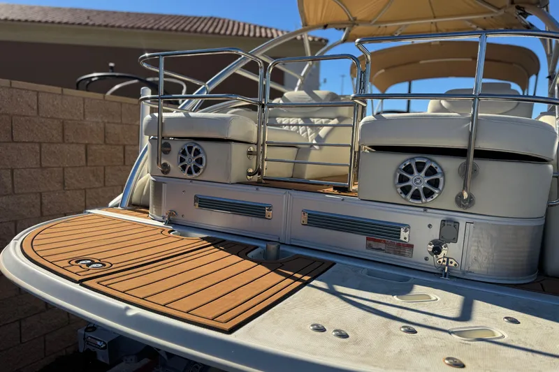 Slide: The Image of 2013 Bennington 2575QCW I/O boat with teak deck and cushioned seating. - 9