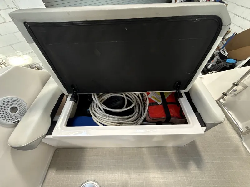 Slide: The Image of Regal 26 XO 2021 boat with open storage compartment and accessories. - 12