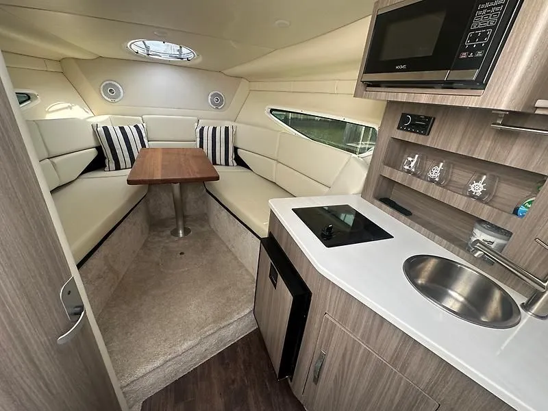 Slide: The Image of Interior of 2021 Regal 26 XO yacht with kitchen and seating area. - 25