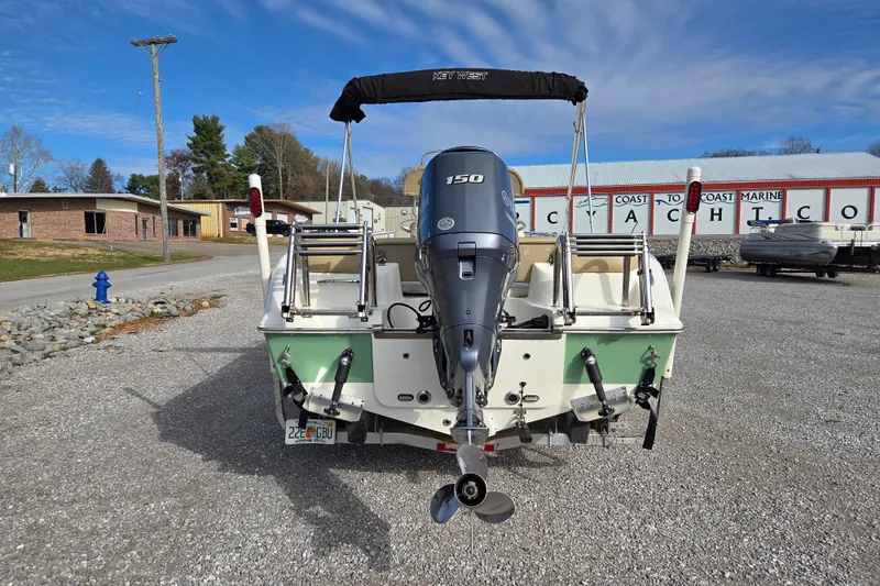 Slide: The Image of 2015 Key West 203 FS boat with Yamaha 150 engine, parked at a marine dealership. - 4