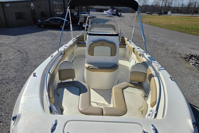 Slide: The Image of 2015 Key West 203 FS boat interior with beige seating and console. - 5