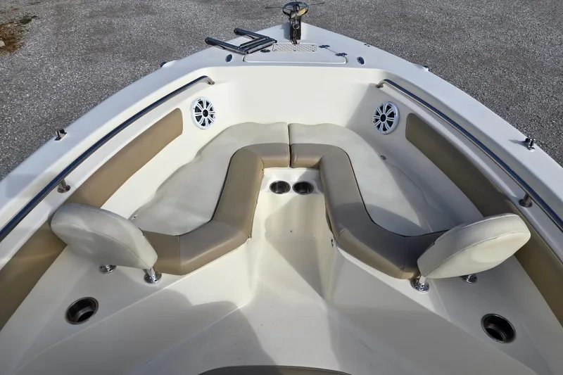 Slide: The Image of 2015 Key West 203 FS boat interior with cushioned seating and cup holders. - 6