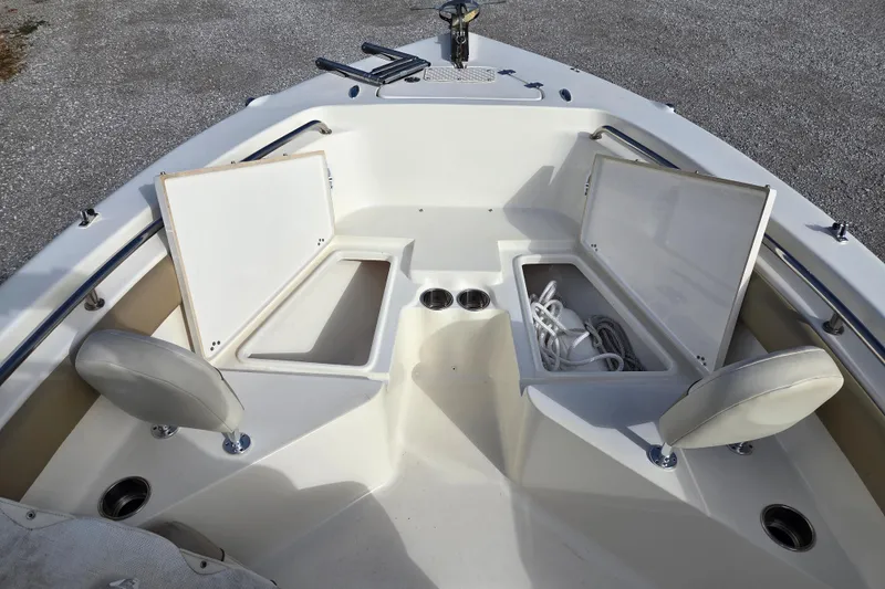 Slide: The Image of 2015 Key West 203 FS boat interior with open storage compartments and seating. - 7