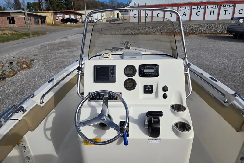 Slide: The Image of 2015 Key West 203 FS boat dashboard with steering wheel and controls. - 9