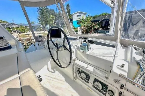 Slide: The Image of Helm of 2006 Lagoon 440 catamaran with steering wheel and navigation instruments. - 16