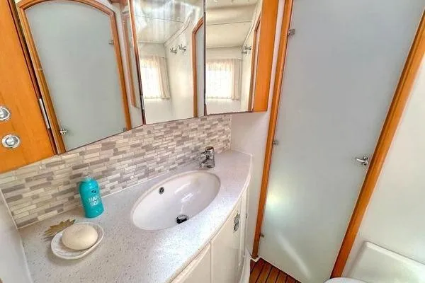 Slide: The Image of Bathroom interior of 2006 Lagoon 440 yacht with modern sink and mirror. - 22
