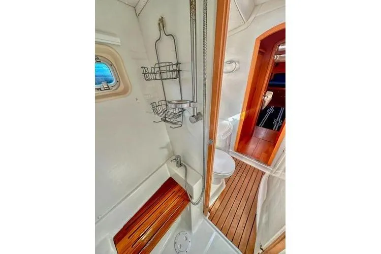 Slide: The Image of Interior of 2006 Lagoon 440 yacht bathroom with shower and wooden flooring. - 24