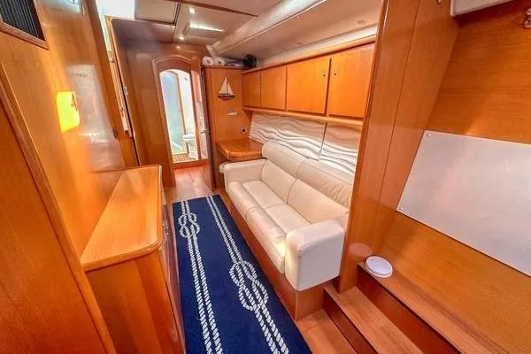 Slide: The Image of Interior of 2006 Lagoon 440 yacht with wooden cabinetry and white sofa. - 28
