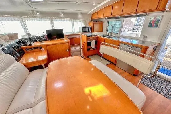 Slide: The Image of Interior of 2006 Lagoon 440 yacht with modern kitchen and dining area. - 42