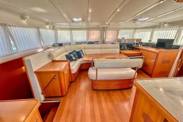 Slide: The Image of Luxurious interior of a 2006 Lagoon 440 yacht with elegant wood finishes and plush seating. - 44