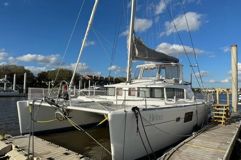 Slide: The Image of 2006 Lagoon 440 catamaran docked under a clear blue sky. - 5