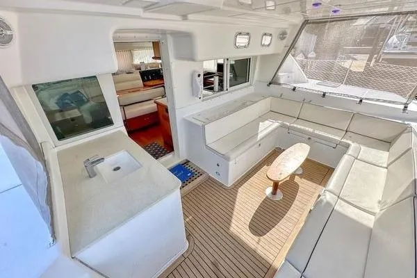 Slide: The Image of Spacious 2006 Lagoon 440 yacht interior with seating, table, and kitchenette. - 50