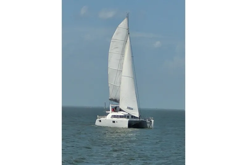 Slide: The Image of Sailing Lagoon 440 catamaran from 2006 on open sea under clear skies. - 8