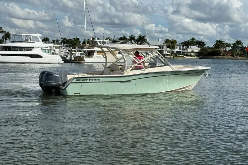 Slide: The Image of 2016 Grady-White Freedom 307 boat on calm water, with Yamaha outboard motor. - 1
