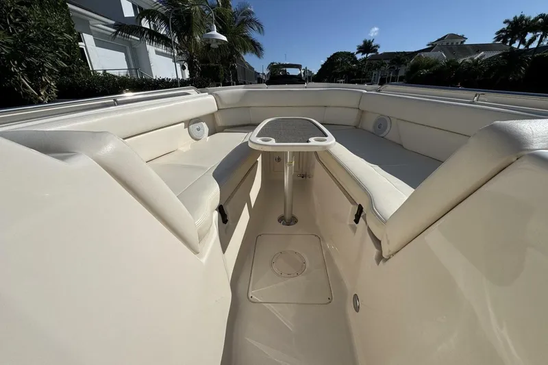 Slide: The Image of 2016 Grady-White Freedom 307 boat interior with cushioned seating and table. - 10