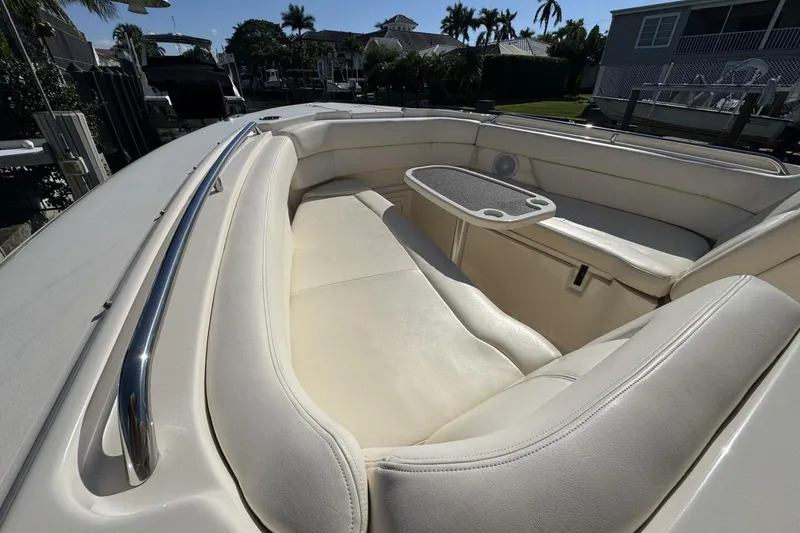 Slide: The Image of 2016 Grady-White Freedom 307 boat interior with white seating and table. - 12