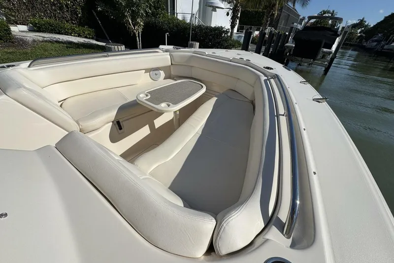 Slide: The Image of 2016 Grady-White Freedom 307 boat interior with cushioned seating and table. - 13