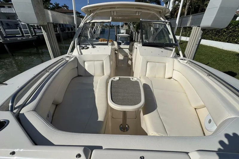 Slide: The Image of 2016 Grady-White Freedom 307 boat interior with white seating and table. - 14