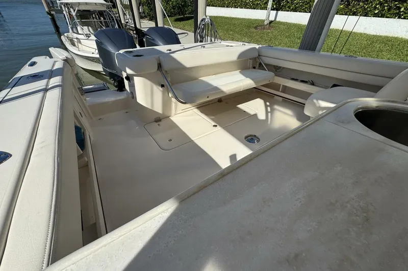 Slide: The Image of 2016 Grady-White Freedom 307 boat interior with seating and dual outboard motors. - 21
