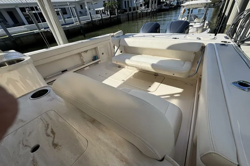Slide: The Image of 2016 Grady-White Freedom 307 boat interior with beige seating and cup holders. - 22