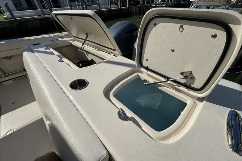 Slide: The Image of 2016 Grady-White Freedom 307 boat with open storage compartments and cup holder. - 26