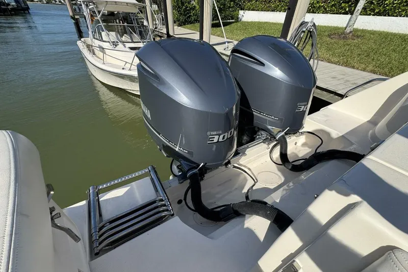 Slide: The Image of 2016 Grady-White Freedom 307 with twin Yamaha 300 engines docked by the water. - 30