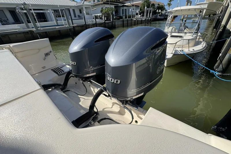 Slide: The Image of 2016 Grady-White Freedom 307 boat with twin Yamaha 300 engines docked by waterfront homes. - 31