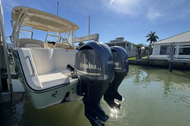 Slide: The Image of 2016 Grady-White Freedom 307 boat with twin Yamaha 300 engines docked by waterfront homes. - 33