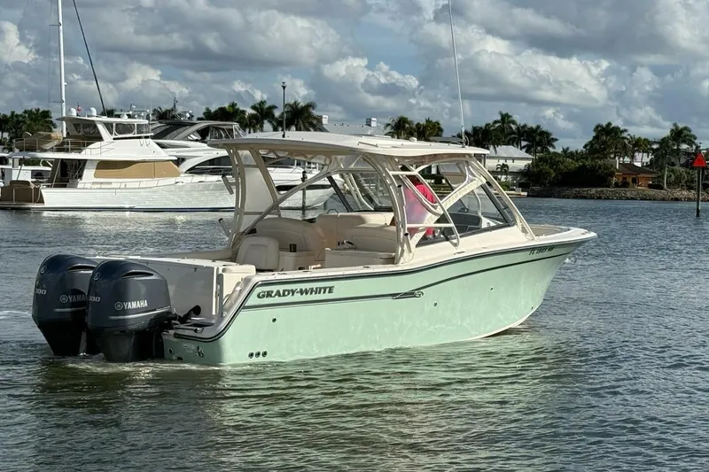 Slide: The Image of 2016 Grady-White Freedom 307 boat with twin Yamaha engines on calm water. - 35