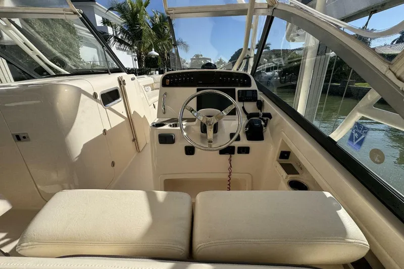 Slide: The Image of 2016 Grady-White Freedom 307 boat interior with steering wheel and seating. - 5