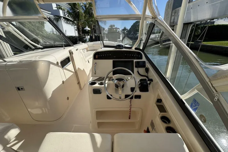 Slide: The Image of 2016 Grady-White Freedom 307 boat interior with steering wheel and control panel. - 7